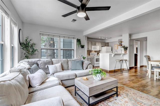 6711 S Ivy Way Unit A2, Centennial, CO 80112 - living room featuring ceiling fan and light wood-style flooring