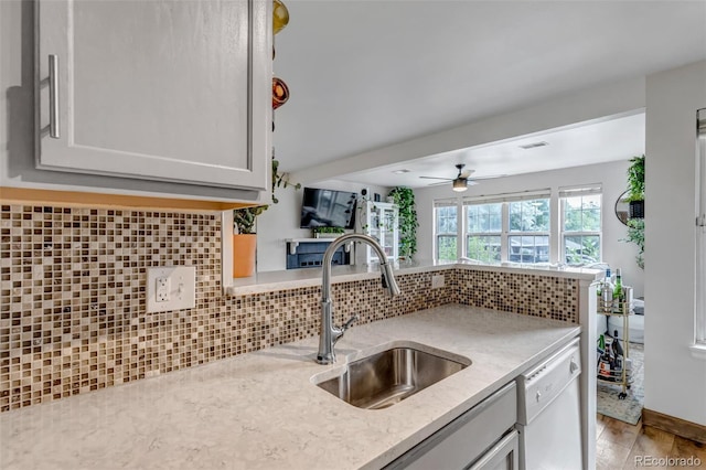 6711 S Ivy Way Unit A2, Centennial, CO 80112 - kitchen with dishwasher, decorative backsplash, light wood-type flooring, ceiling fan, and light stone counters