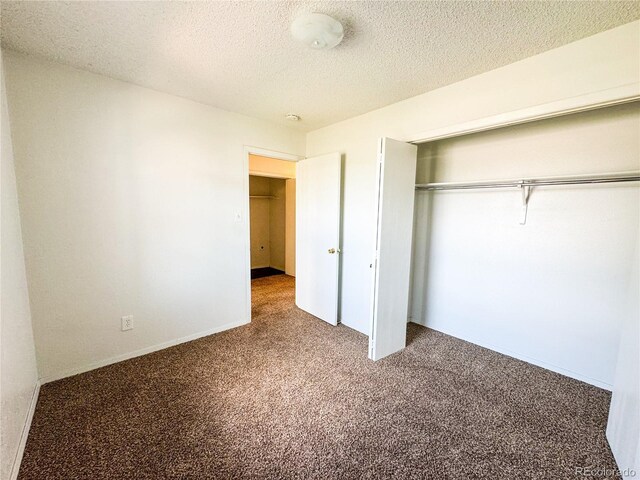 1700 S 6th Ave, Sterling, CO 80751 - unfurnished bedroom with carpet floors, a closet, and a textured ceiling