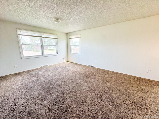 1700 S 6th Ave, Sterling, CO 80751 - empty room featuring carpet flooring and a textured ceiling