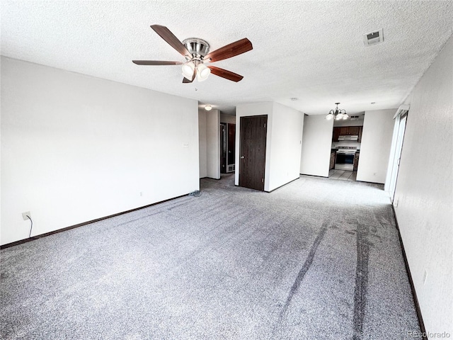 1700 S 6th Ave, Sterling, CO 80751 - spare room with light carpet, ceiling fan, a chandelier, baseboards, and a textured ceiling
