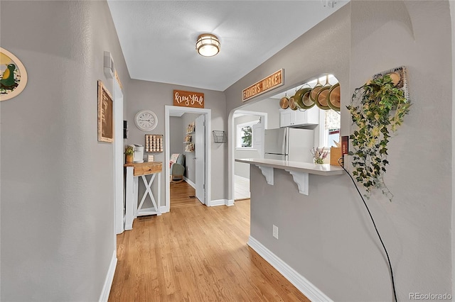 interior space featuring light hardwood / wood-style flooring and a textured ceiling