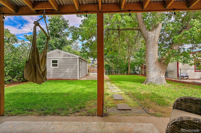 view of yard with a fenced backyard and an outbuilding