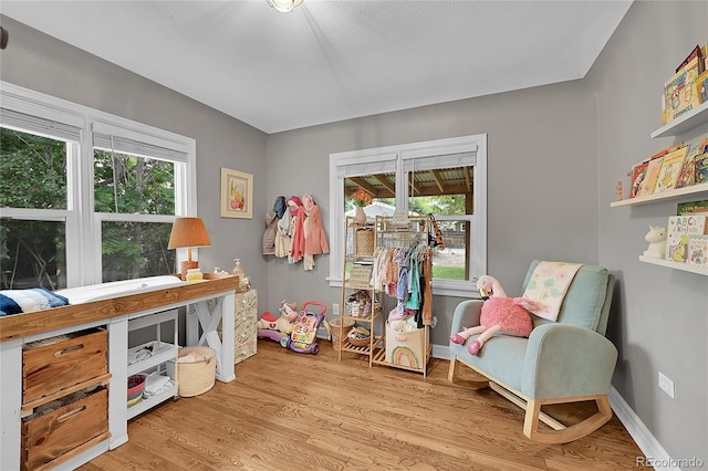 sitting room with a wealth of natural light and light wood-type flooring