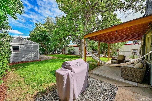 view of yard with an outbuilding, a patio area, and fence