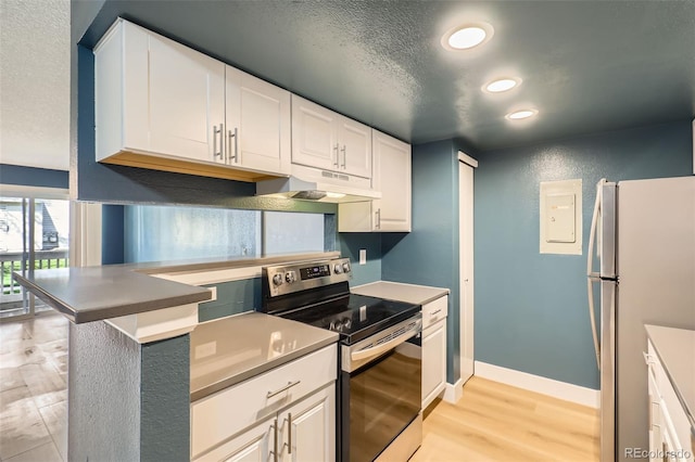 kitchen featuring recessed lighting, light wood finished floors, under cabinet range hood, freestanding refrigerator, and electric range