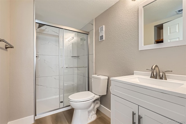 bathroom featuring toilet, visible vents, wood finished floors, a shower stall, and a textured wall