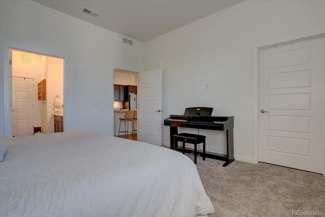 bedroom with carpet floors and ensuite bathroom