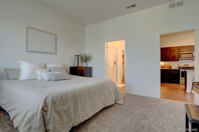 carpeted bedroom with ensuite bathroom