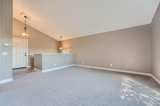 unfurnished room featuring baseboards, carpet floors, and vaulted ceiling