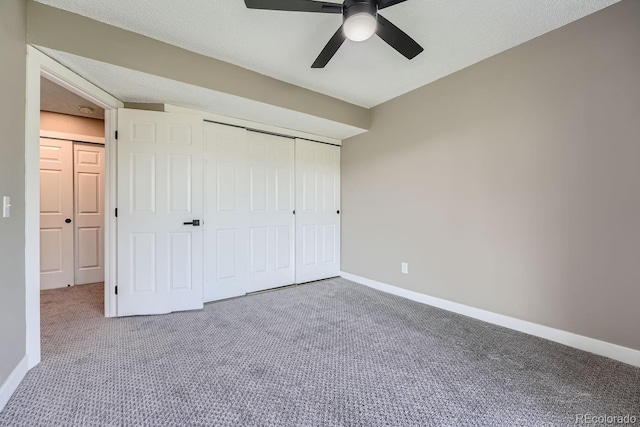 unfurnished bedroom with a closet, ceiling fan, baseboards, and carpet