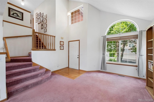 11366 Haswell Dr, Parker, CO 80134 - entryway featuring carpet, stairway, and high vaulted ceiling