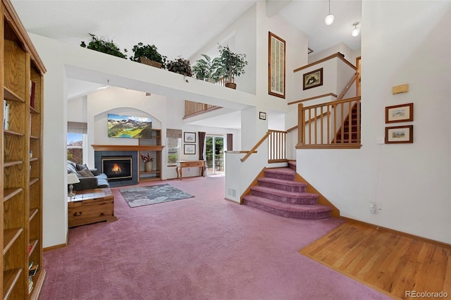 11366 Haswell Dr, Parker, CO 80134 - foyer with a towering ceiling, stairs, a fireplace, and carpet floors