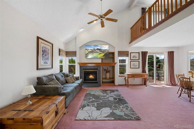 11366 Haswell Dr, Parker, CO 80134 - carpeted living area featuring a tile fireplace, a ceiling fan, and high vaulted ceiling
