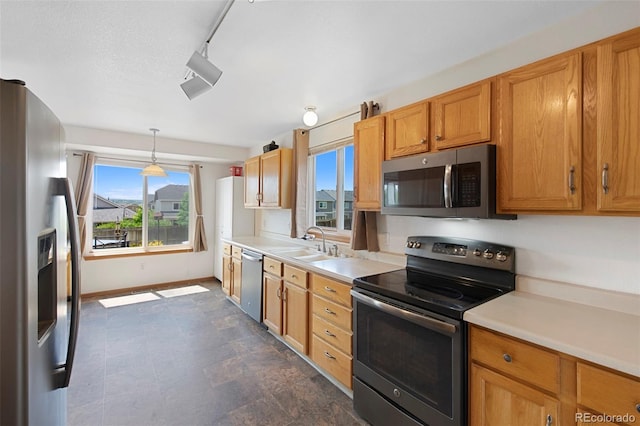 11366 Haswell Dr, Parker, CO 80134 - kitchen with stainless steel appliances, light countertops, healthy amount of natural light, and decorative light fixtures