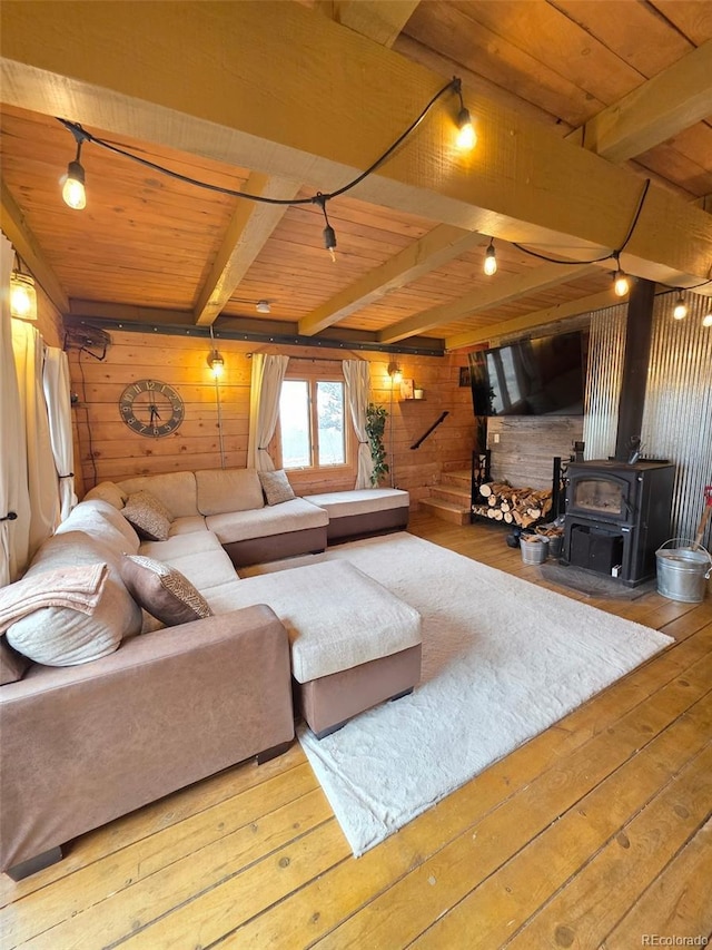 253 Bear Ln, Jefferson, CO 80456 - living room with wooden walls, a wood stove, a wood ceiling with exposed beams, wood-type flooring, and rail lighting