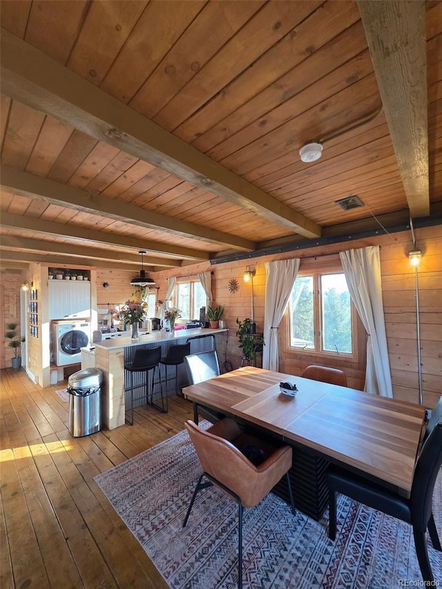 253 Bear Ln, Jefferson, CO 80456 - dining room with wood walls, washer / dryer, a wood ceiling with exposed beams, and wood-type flooring