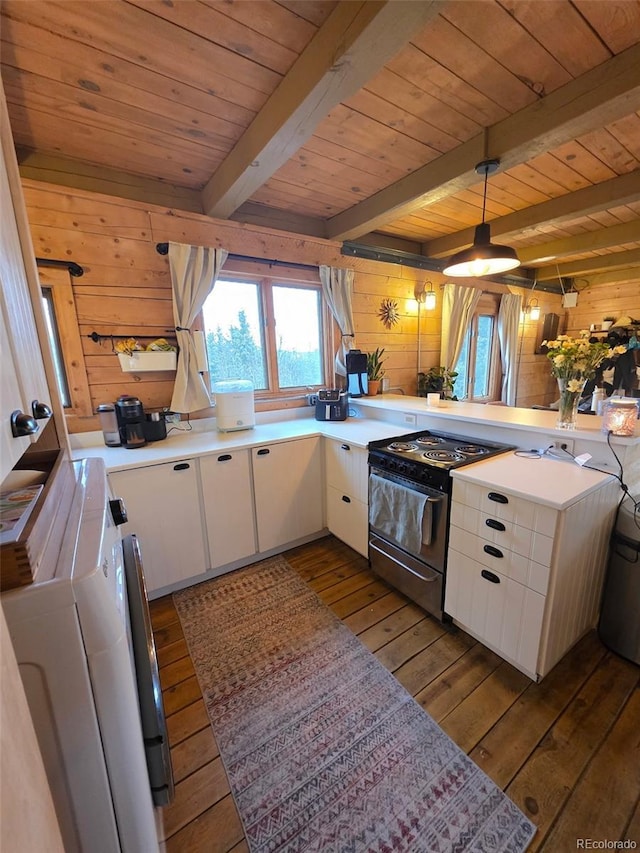 253 Bear Ln, Jefferson, CO 80456 - kitchen featuring stainless steel range with electric cooktop, a wood ceiling with exposed beams, wood walls, hardwood / wood-style floors, and white cabinetry