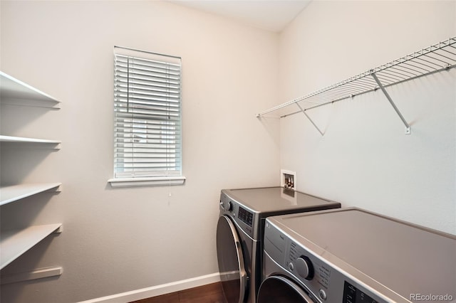 laundry area with washing machine and dryer and dark hardwood / wood-style floors