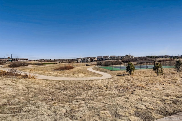 view of home's community featuring a rural view and tennis court