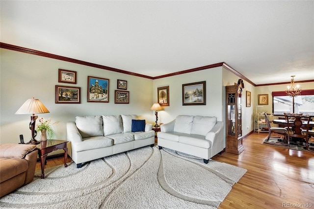 2140 S Youngfield St, Lakewood, CO 80228 - living room featuring crown molding, baseboards, an inviting chandelier, and wood finished floors