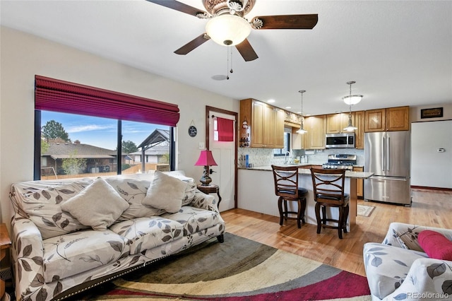 2140 S Youngfield St, Lakewood, CO 80228 - living area with light wood-style floors and ceiling fan