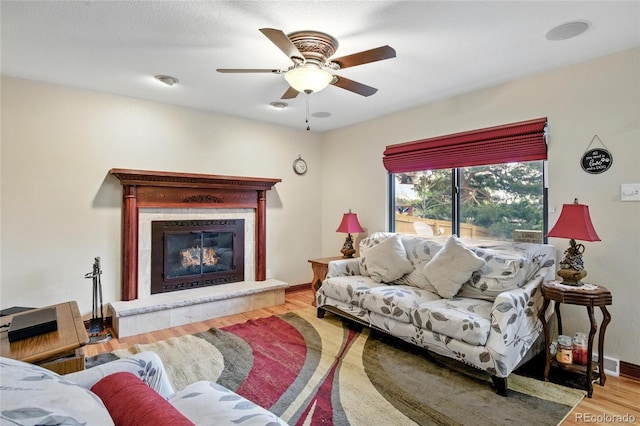 2140 S Youngfield St, Lakewood, CO 80228 - living area featuring baseboards, ceiling fan, wood finished floors, and a tile fireplace