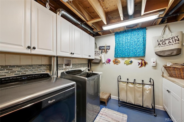 2140 S Youngfield St, Lakewood, CO 80228 - laundry room with baseboards, cabinet space, and washing machine and clothes dryer