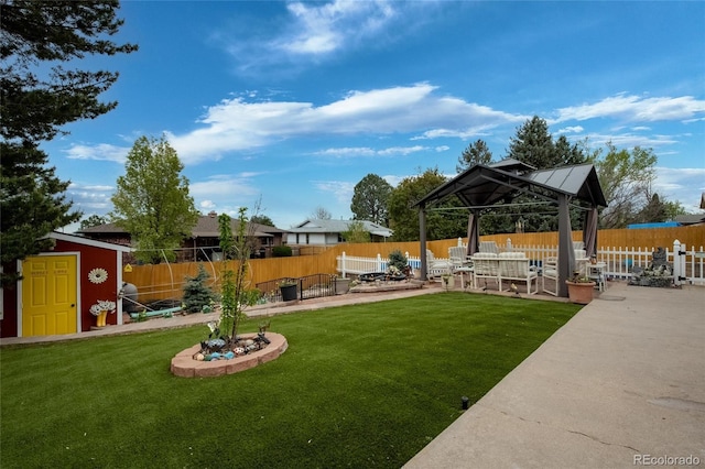 2140 S Youngfield St, Lakewood, CO 80228 - view of yard featuring an outdoor structure, a fenced backyard, a storage unit, a patio area, and a gazebo