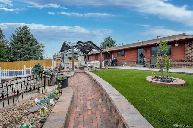 2140 S Youngfield St, Lakewood, CO 80228 - rear view of house with a yard, brick siding, fence, and a patio area