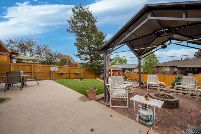 2140 S Youngfield St, Lakewood, CO 80228 - view of patio / terrace featuring outdoor dining area, a fenced backyard, and a fire pit