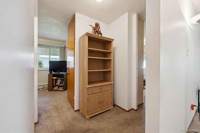 710 S Clinton St Unit 1A, Denver, CO 80247 - corridor with a baseboard radiator, light carpet, and a textured ceiling