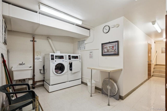 710 S Clinton St Unit 1A, Denver, CO 80247 - communal laundry room with washing machine and clothes dryer and baseboards