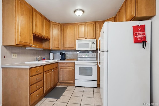 710 S Clinton St Unit 1A, Denver, CO 80247 - kitchen with white appliances, a sink, light countertops, backsplash, and light tile patterned floors