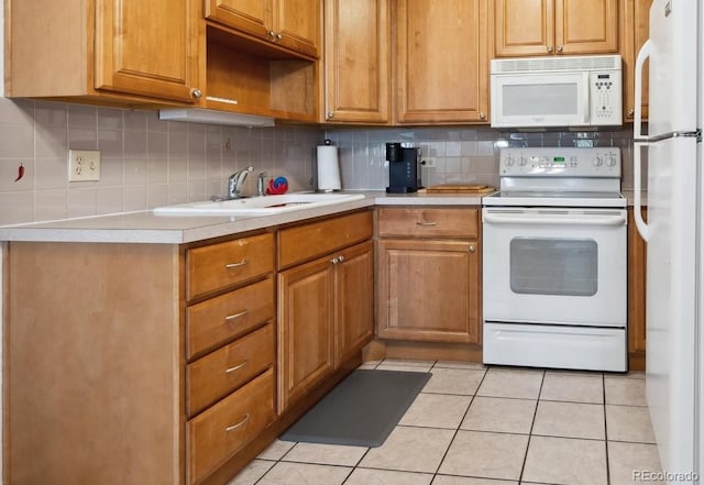 710 S Clinton St Unit 1A, Denver, CO 80247 - kitchen with white appliances, light countertops, decorative backsplash, and light tile patterned floors