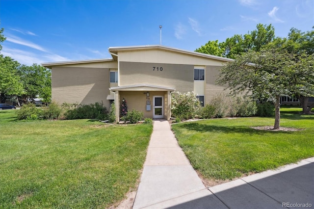 710 S Clinton St Unit 1A, Denver, CO 80247 - view of front of house with a front lawn