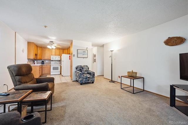 710 S Clinton St Unit 1A, Denver, CO 80247 - living area with light colored carpet, a ceiling fan, and a textured ceiling