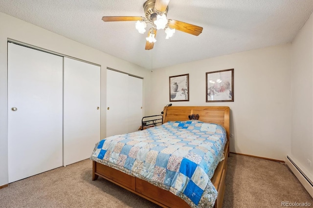 710 S Clinton St Unit 1A, Denver, CO 80247 - carpeted bedroom featuring a baseboard heating unit, two closets, a ceiling fan, and a textured ceiling