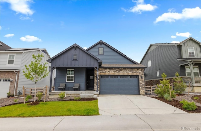 8132 Mt Harvard Rd, Littleton, CO 80125 - craftsman-style home with a porch, board and batten siding, a garage, concrete driveway, and a front lawn