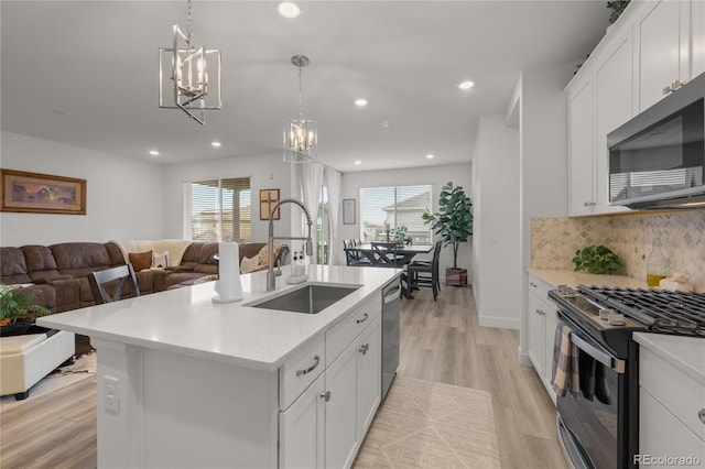 8132 Mt Harvard Rd, Littleton, CO 80125 - kitchen with stainless steel appliances, a sink, open floor plan, healthy amount of natural light, and recessed lighting