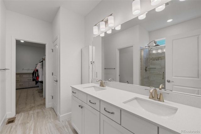 8132 Mt Harvard Rd, Littleton, CO 80125 - bathroom featuring a stall shower, double vanity, a spacious closet, and baseboards