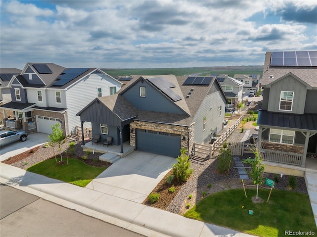 8132 Mt Harvard Rd, Littleton, CO 80125 - view of front of property featuring board and batten siding, a residential view, concrete driveway, stone siding, and solar panels