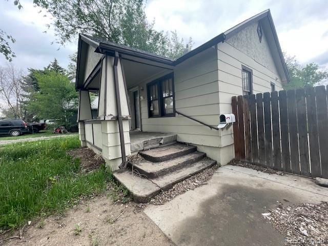 2771 W 1st Ave, Denver, CO 80219 - view of property exterior featuring covered porch and fence