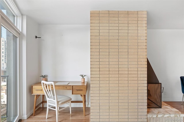 home office featuring light wood-type flooring and a wealth of natural light