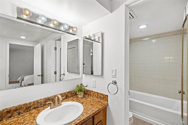 full bathroom featuring vanity, toilet, and tiled shower / bath combo