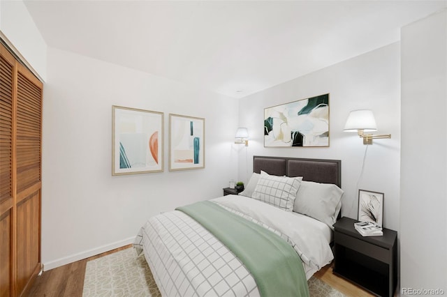 bedroom with hardwood / wood-style flooring and a closet