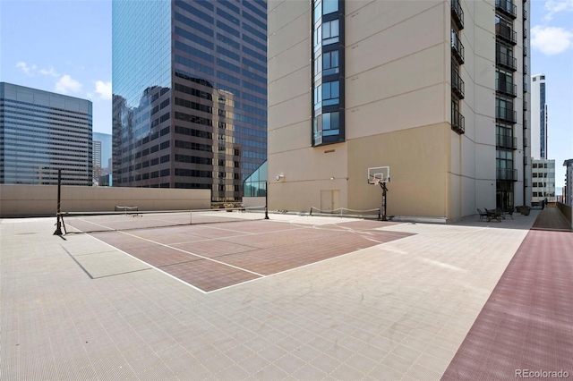 view of tennis court featuring basketball hoop