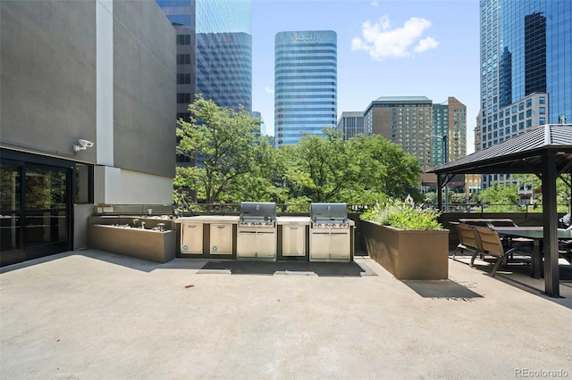 view of patio featuring a gazebo, an outdoor kitchen, and area for grilling