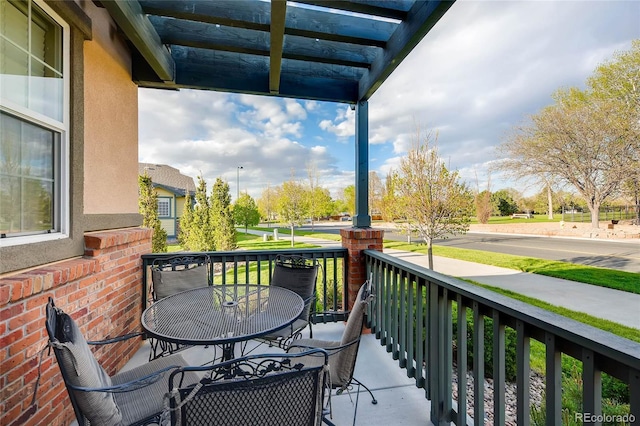 balcony with outdoor dining space and a porch
