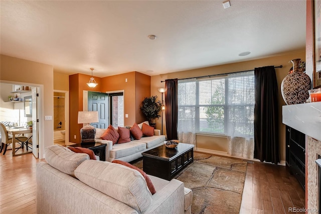 living room featuring hardwood / wood-style floors and baseboards